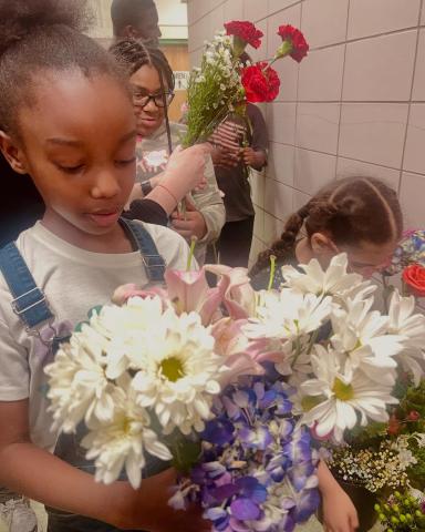 child with flower arrangements